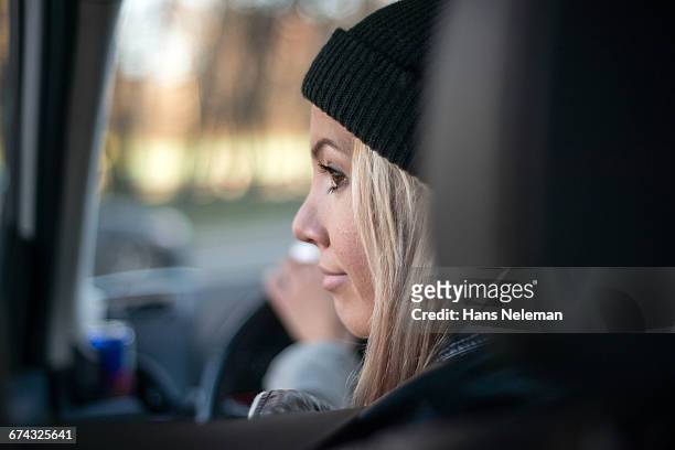 rear view of woman driving a car - close up of beautiful young blonde woman with black hat stock pictures, royalty-free photos & images