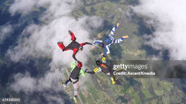 pov of skydivers in freefall, over rural landscape - skydiving stock pictures, royalty-free photos & images