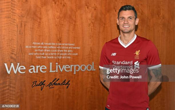 Dejan Lovren poses as he signs a new four-year contract with Liverpool FC at Melwood Training Ground on April 27, 2017 in Liverpool, England.