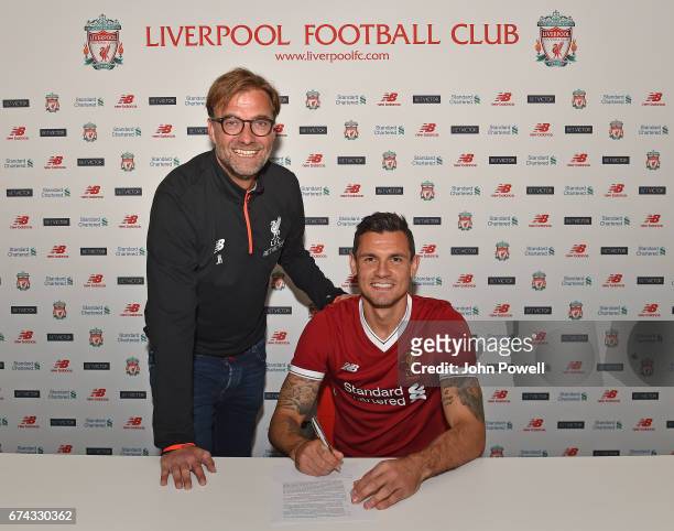 Dejan Lovren poses with manager Jurgen Klopp as he signs a new four-year contract with Liverpool FC at Melwood Training Ground on April 27, 2017 in...