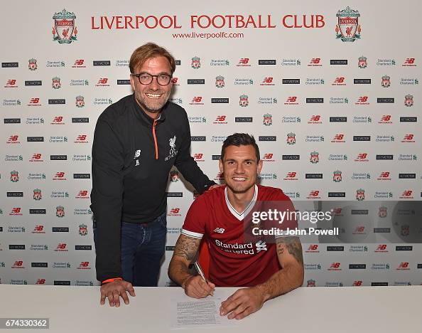 Dejan Lovren poses with manager Jurgen Klopp as he signs a new