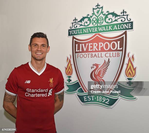 Dejan Lovren poses as he signs a new four-year contract with Liverpool FC at Melwood Training Ground on April 27, 2017 in Liverpool, England.