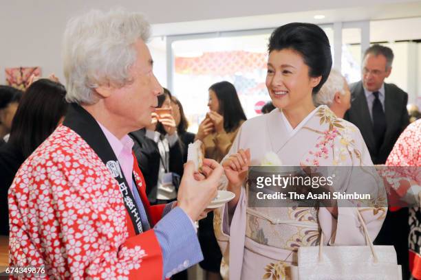 Former Prime Minister Junichiro Koizumi and actress Norika Fujiwara talk during the event to harvest rice from a rice paddy at Pasona Holdings...
