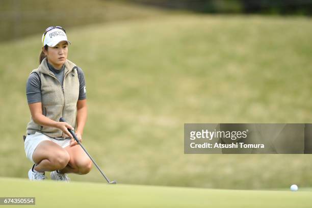 Asako Fujimoto of Japan lines up her putt on the 1st hole during the first round of the CyberAgent Ladies Golf Tournament at the Grand Fields Country...