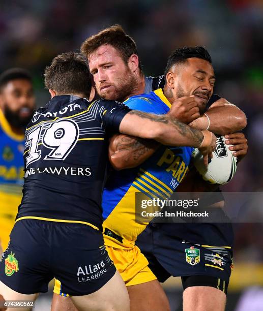 Kenneth Edwards of the Eels is tackled by Gavin Cooper and Benjamin Hampton of the Cowboys during the round nine NRL match between the North...