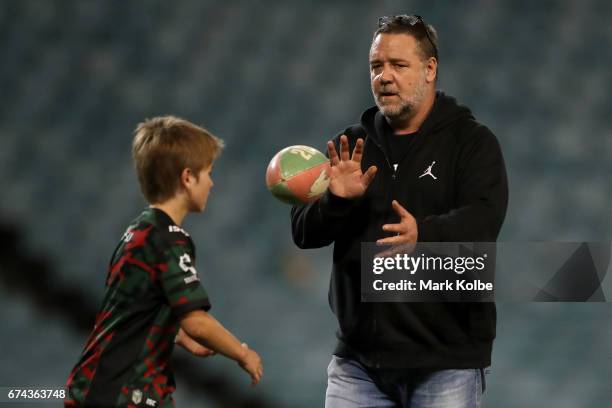 South Sydney Rabbitohs football club owner and actor Russell Crowe kicks a football on the field after the round nine NRL match between the South...