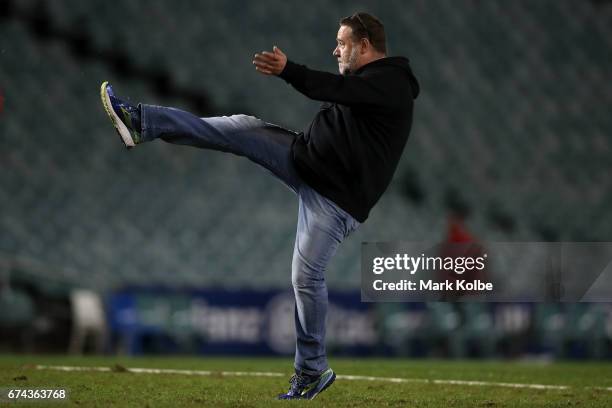 South Sydney Rabbitohs football club owner and actor Russell Crowe kicks a football on the field after the round nine NRL match between the South...