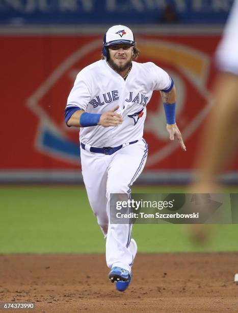 Jarrod Saltalamacchia of the Toronto Blue Jays tags up from second base and advances to third base on a fly ball out in the sixth inning during MLB...