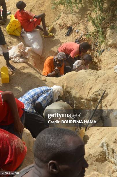 People dig as hundreds of people search gold on April 25, 2017 in Kafa-Koira, south of Niamey. Hundreds of people, sometimes whole families, rush to...