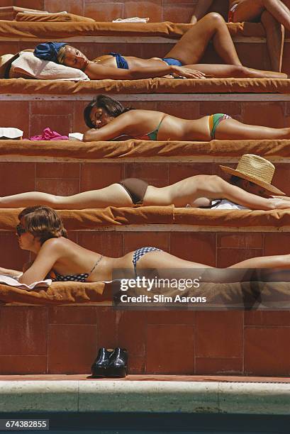 Sunbathers by a swimming pool at the Hotel Punta Tragara on the island of Capri, Italy, August 1974.