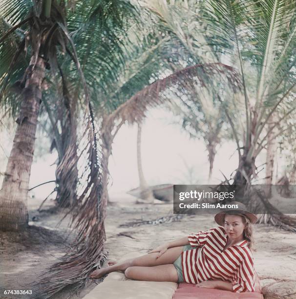 Marsha Gayle of Paris enjoys a deserted beach near Calabash Bay, Andros, Bahamas, 1957.