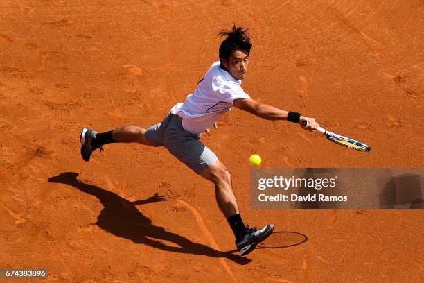 Yuichi Sugita of Japan plays a backhand against Dominic Thiem of Austria on day five of the Barcelona Open Banc Sabadell in the quarterfinal on day...