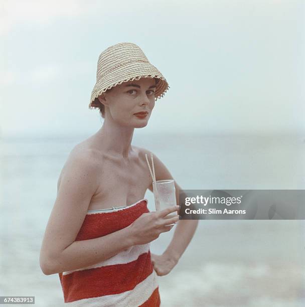Actress Dee Hartford, wife of film producer Howard Hawks, sips a Pussyfoot - a mixture of Jamaican fruit juices, 1958.