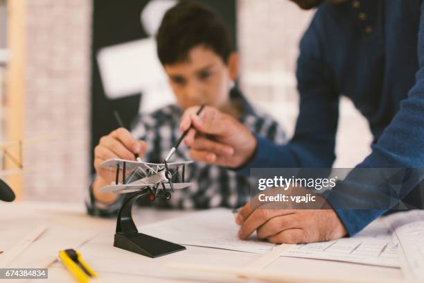 father and son making toy plane - life drawing model stock pictures, royalty-free photos & images