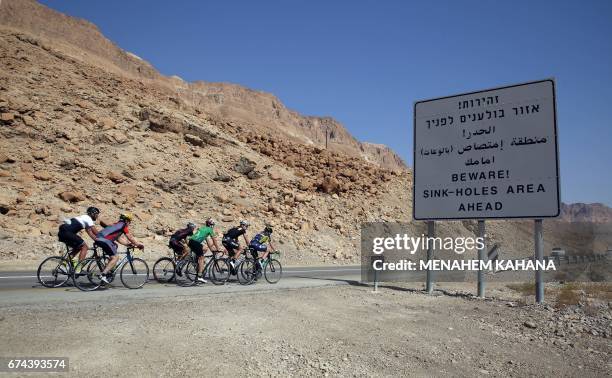 Foreign and Israeli cyclists ride on the road along the Dead Sea in the Israeli-section of the Judaean desert, during the fifth and the last day of...