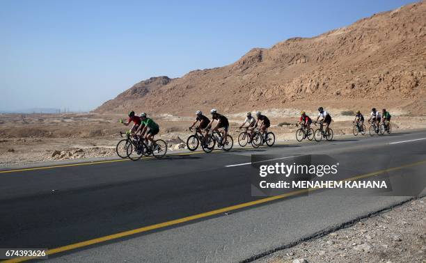 Foreign and Israeli cyclists ride on the road along the Dead Sea in the Israeli-section of the Judaean desert, during the fifth and the last day of...
