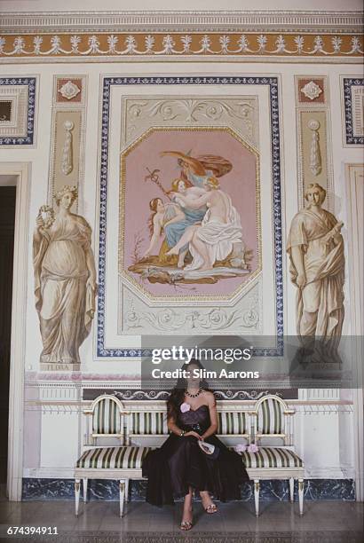 Donna Anna Monroy di Giampilieri in the early-Empire drawing room of the Villa Spedalotto, near Palermo, Sicily, 1984.