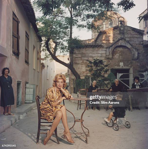 Actress Melina Mercouri enjoys a coffee and a cigarette at a quiet pavement cafe, Plaka, Athens, 1961.