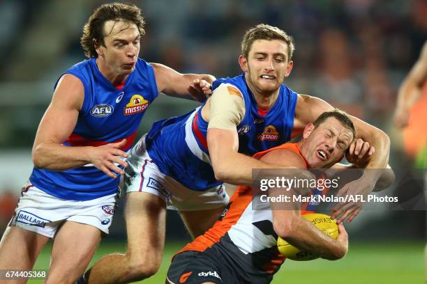 Fletcher Roberts of the Bulldogs tackles Steve Johnson of the Giants during the round six AFL match between the Greater Western Sydney Giants and the...