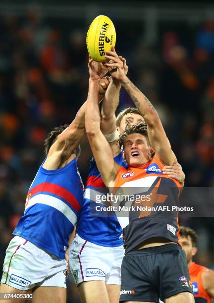 Rory Lobb of the Giants and Marcus Adams and Fletcher Roberts of the Bulldogs contest a mark during the round six AFL match between the Greater...