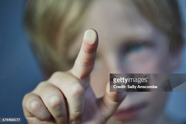 child touching a screen - children screen stock-fotos und bilder