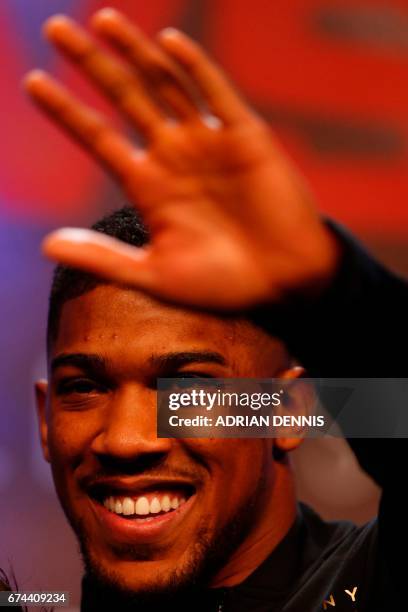 British boxer Anthony Joshua gestures during the weigh-in event at Wembley in London on April 28, 2017 ahead of his world heavyweight title...