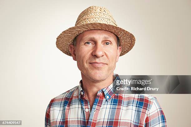 portrait of middle-aged man in sun hat - sun hat stock pictures, royalty-free photos & images