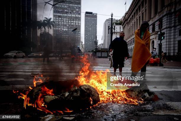 Demonstrators set barricades on fire at Rua Xavier de Toledo in Sao Paulo, Brazil on April 28, 2017. A nation-wide general strike has been called...