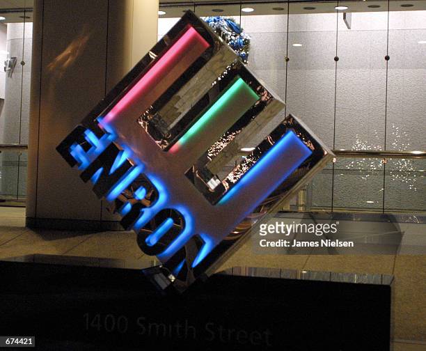 Logo glows in front of the new corporate headquarters of the Houston-based energy trading firm Enron November 29, 2001 in Houston, Texas. The energy...