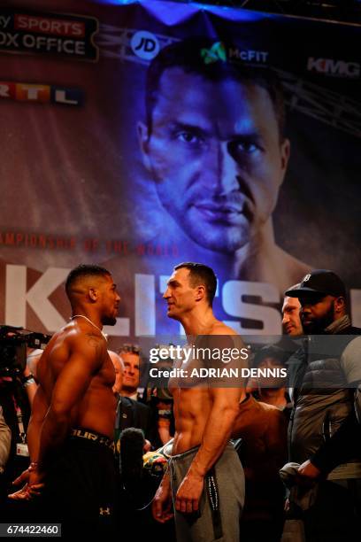 British boxer Anthony Joshua and Ukrainian boxer Wladimir Klitschko face each other during the weigh-in ahead of their world heavyweight title...
