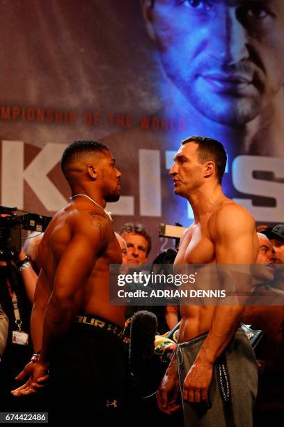 British boxer Anthony Joshua and Ukrainian boxer Wladimir Klitschko face each other during the weigh-in ahead of their world heavyweight title...
