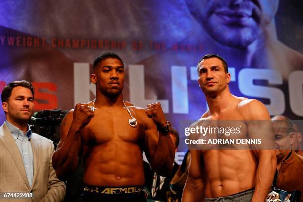 British boxer Anthony Joshua and Ukrainian boxer Wladimir Klitschko pose with each other during the weigh-in ahead of their world heavyweight title...