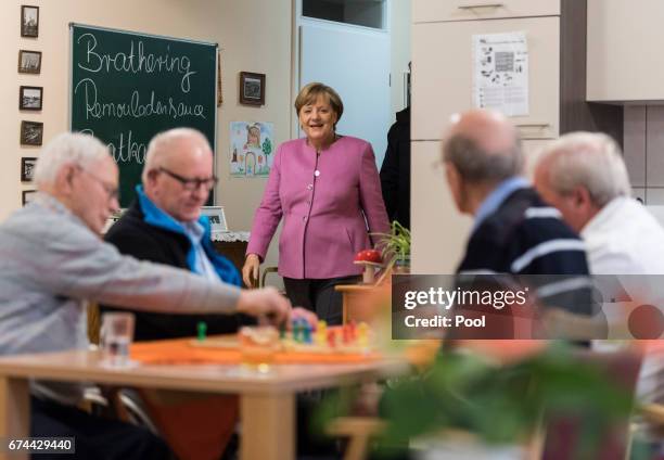 German Chancellor Angela Merkel arrives to chat with residents during a visit to the Gustav-Schatz-Hof senior care facility on April 28, 2017 in...