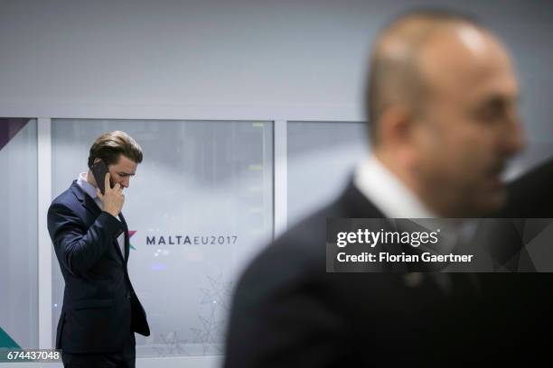 Mevluet Cavusoglu, Foreign Minister of Turkey, is pictured in front of Sebastian Kurz, Foreign Minister of Austria , who is seen on the phone before...