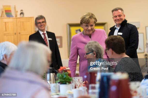 German Chancellor Angela Merkel chats with residents during a visit to the Gustav-Schatz-Hof senior care facility on April 28, 2017 in Kiel, Germany....