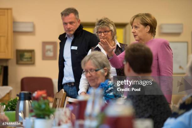 German Chancellor Angela Merkel chats with residents during a visit to the Gustav-Schatz-Hof senior care facility on April 28, 2017 in Kiel, Germany....