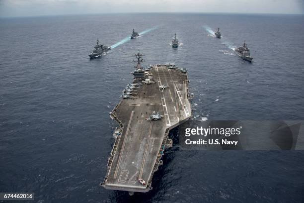 In this handout photo provided by the U.S. Navy, the Nimitz-class aircraft carrier USS Carl Vinson leads the Japan Maritime Self-Defense Force...