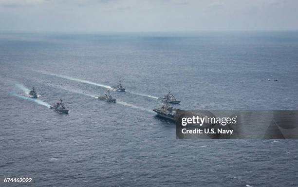 In this handout photo provided by the U.S. Navy, two F/A-18 Super Hornets from Carrier Air Wing 2 and two F-15 Eagles from the Japan Air Self-Defense...