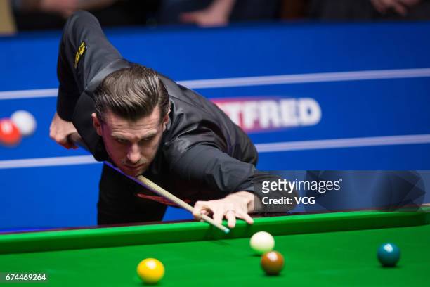 Mark Selby of England plays a shot during his semi-final match against Ding Junhui of China on day 14 of Betfred World Championship 2017 at Crucible...
