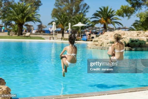 friends jumping into pool - cannon ball pool stock pictures, royalty-free photos & images