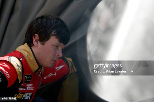 Erik Jones, driver of the GameStop/Prey Toyota, stands in the garage area during practice for the Monster Energy NASCAR Cup Series Toyota Owners 400...