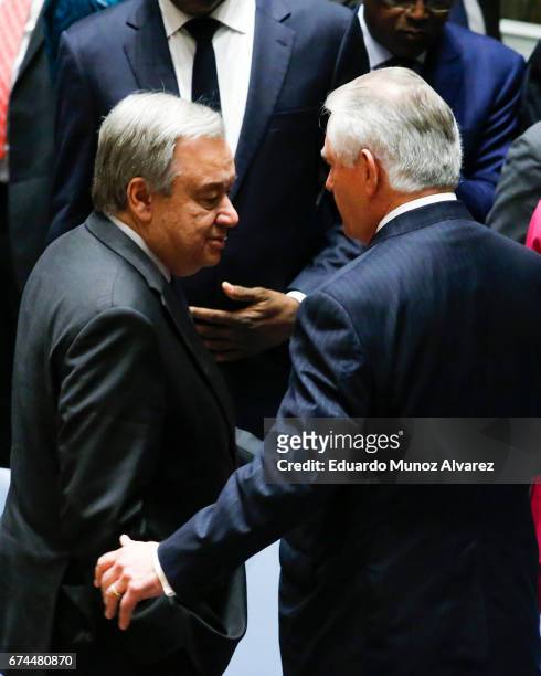 United Nations Secretary General Antonio Guterres speaks with US Secretary of State Rex Tillerson at the end of the security council meeting on...