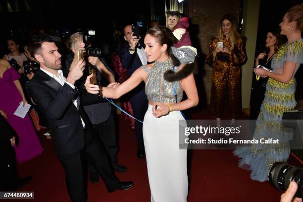 Bruna Marquezine plays and takes photos during the 7th Annual amfAR Inspiration Gala on April 27, 2017 in Sao Paulo, Brazil.