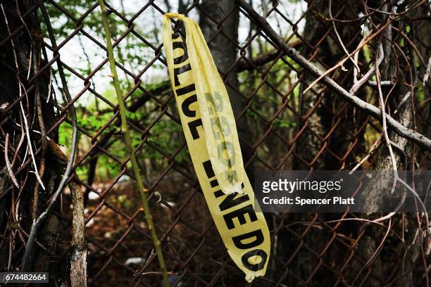 Crime scene tape is still visible in an area where the bodies of four brutally beaten young men were recently discovered on April 28, 2017 in Central...