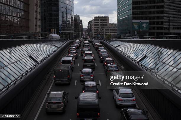 Rush hour traffic slowly makes its way through central Brussels past the European Union Commission headquarters on April 28, 2017 in Brussels,...