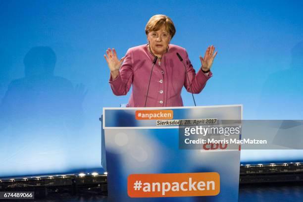 German Chancellor and Chairwoman of the German Christian Democrats Angela Merkel gestures as she speaks to supporters during the opening CDU campaign...