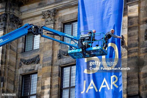 Men on a crane during the exhibition in the Royal Palace that gives an overview of 50 years Netherlands with a combination of objects of King...