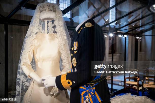 King Willem-Alexander of the Netherlands' wedding suit and Queen Maxima of the Netherlands' wedding dress on display at the exhibition in the Royal...