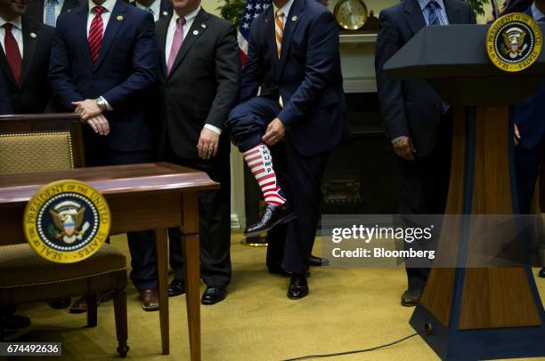 Senator Jeff Duncan, a Republican from South Carolina, rolls up his pant leg to display a sock bearing the name of U.S. President Donald Trump before...