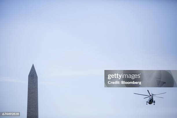 Marine One, with U.S. President Donald Trump on-board, flies near the Washington Monument in Washington, D.C., U.S., on Friday, April 28, 2017. The...